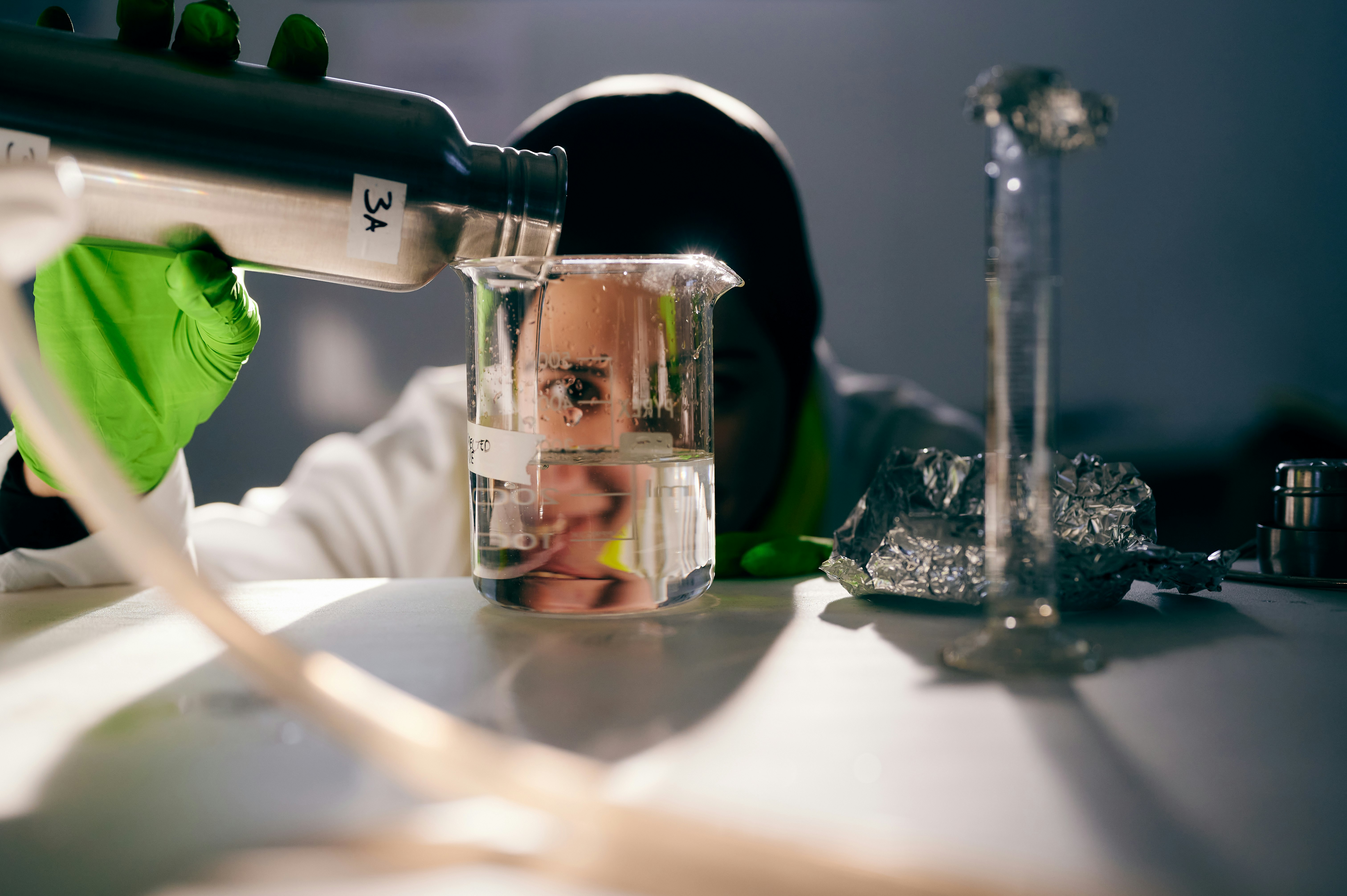 Female scientist eyes a test tube in a lab